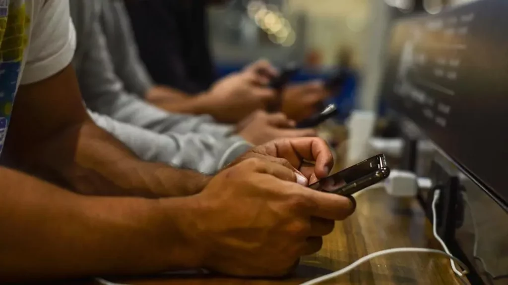 People charging smartphones at phone power stations