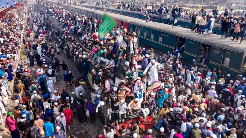 Festival attendees searching for phone charging spots on a crowded platform.