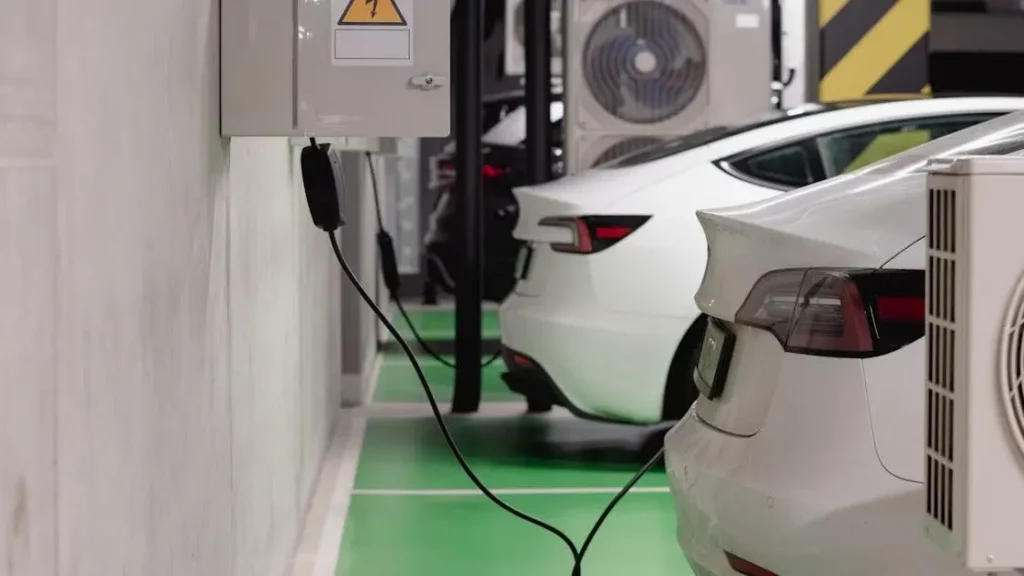 Electric vehicles charging in an underground garage, encourages longer visits.