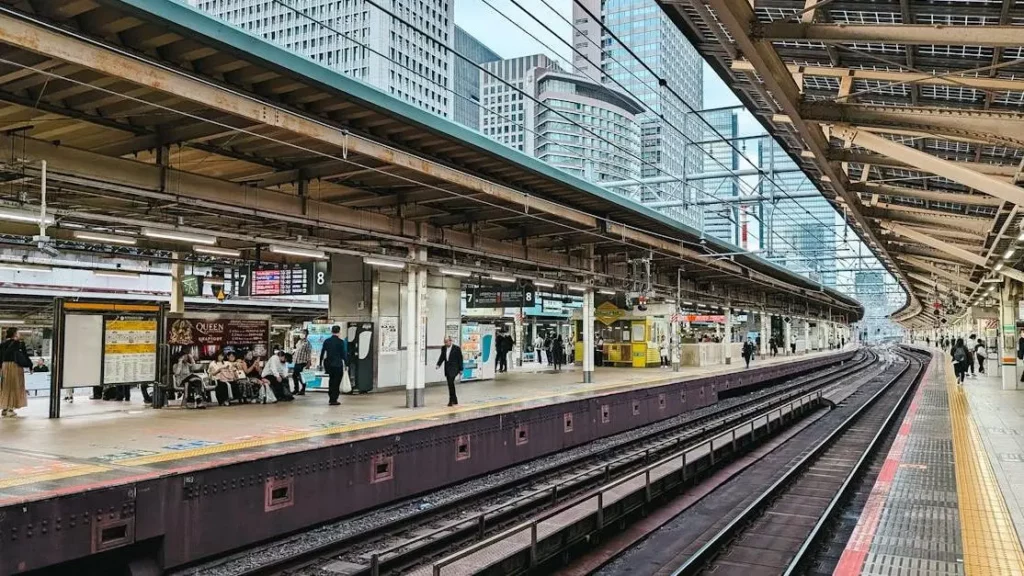 Bustling railway station platform highlighting phone charging solutions for high-traffic venues.