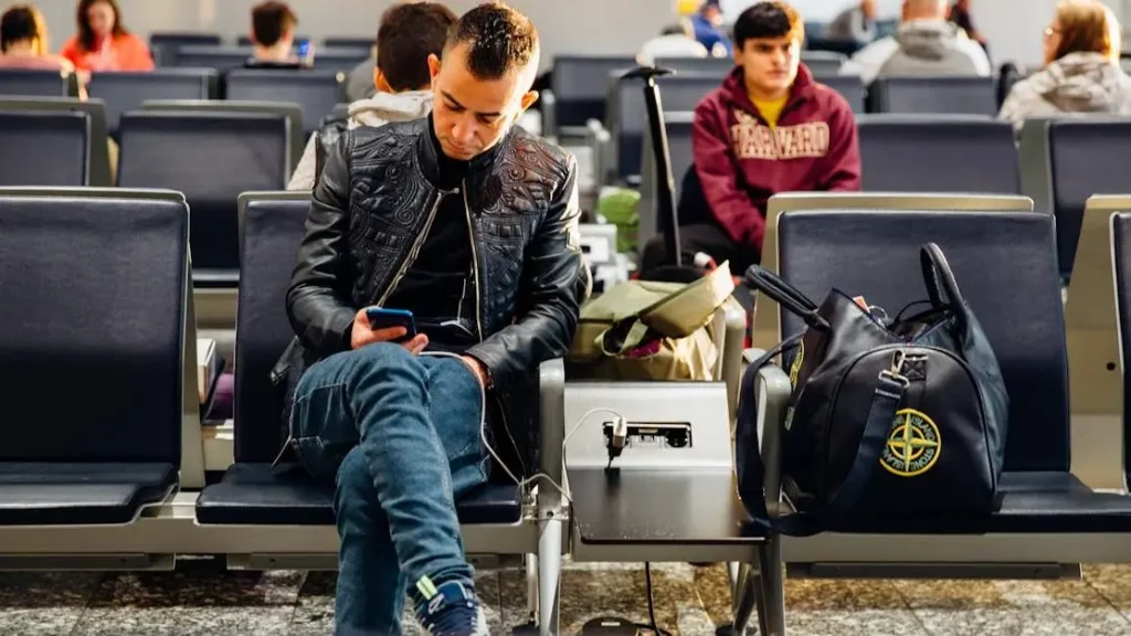 Airport travelers using portable charging stations, illustrating how they improve customer retention.