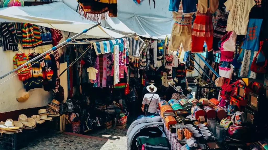 Bustling flea market stall with traditional crafts, offering mobile charging in an inviting atmosphere.