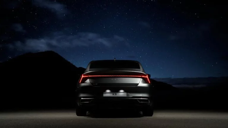 Charging On-the-Go at Drive-in Theaters with a sleek black car under a starry sky.