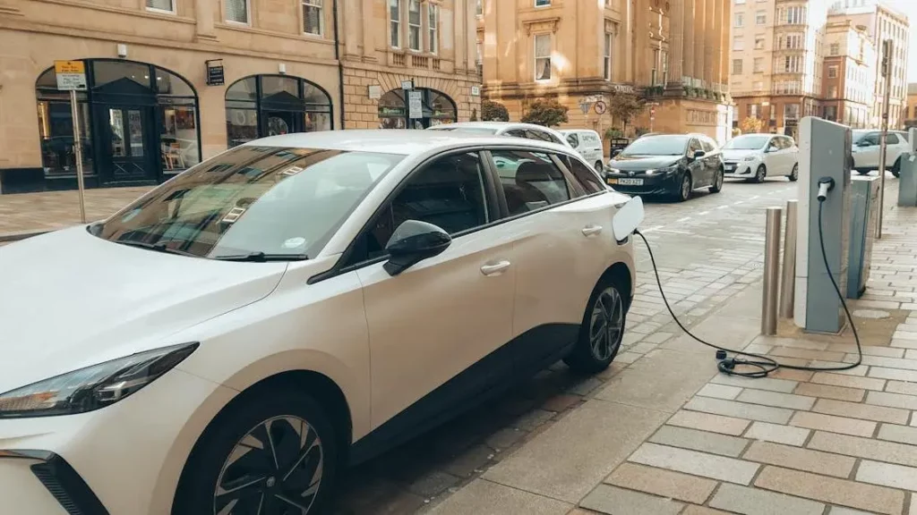 Electric car at charging station in Glasgow: Hospitality industry trends.