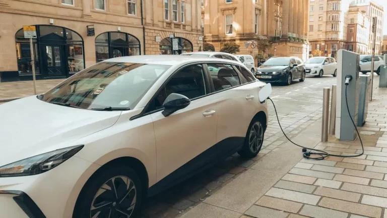 Electric car at charging station in Glasgow: Hospitality industry trends.